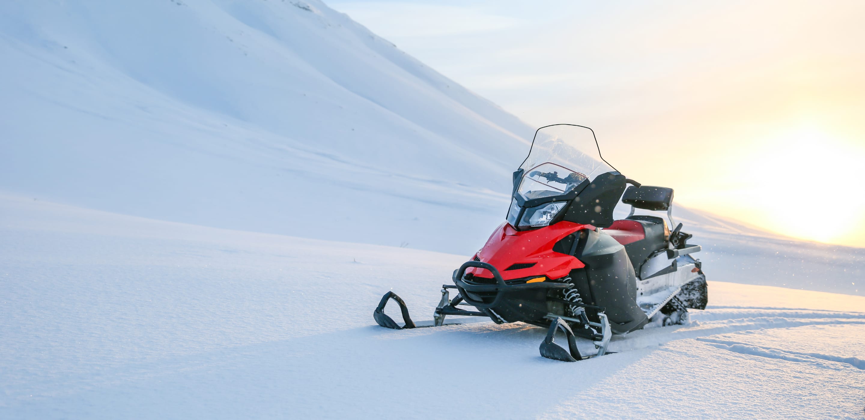 a snowmobile parked in a snowy landscape