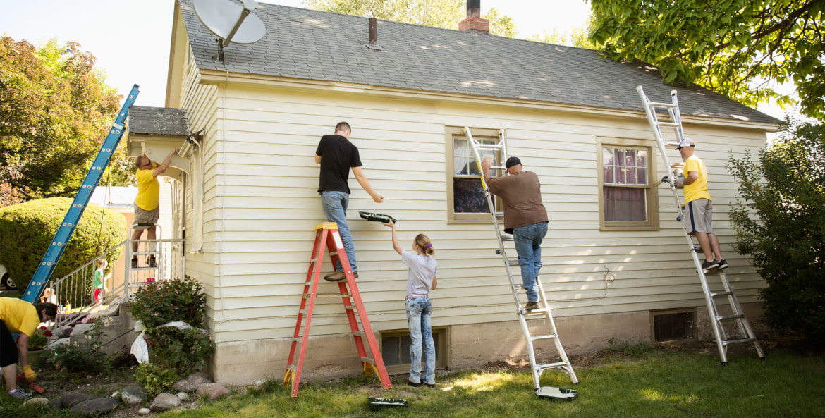 group of six painting a house, picture