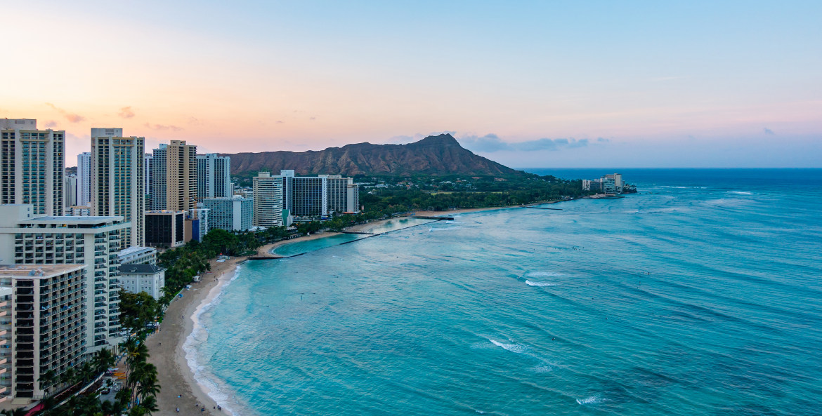 The sun sets over Waikiki in Honolulu, Hawaii on a clear day, image