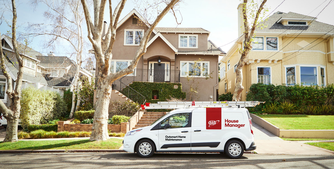 AAA House Manager van parked in front of a two-story house, picture