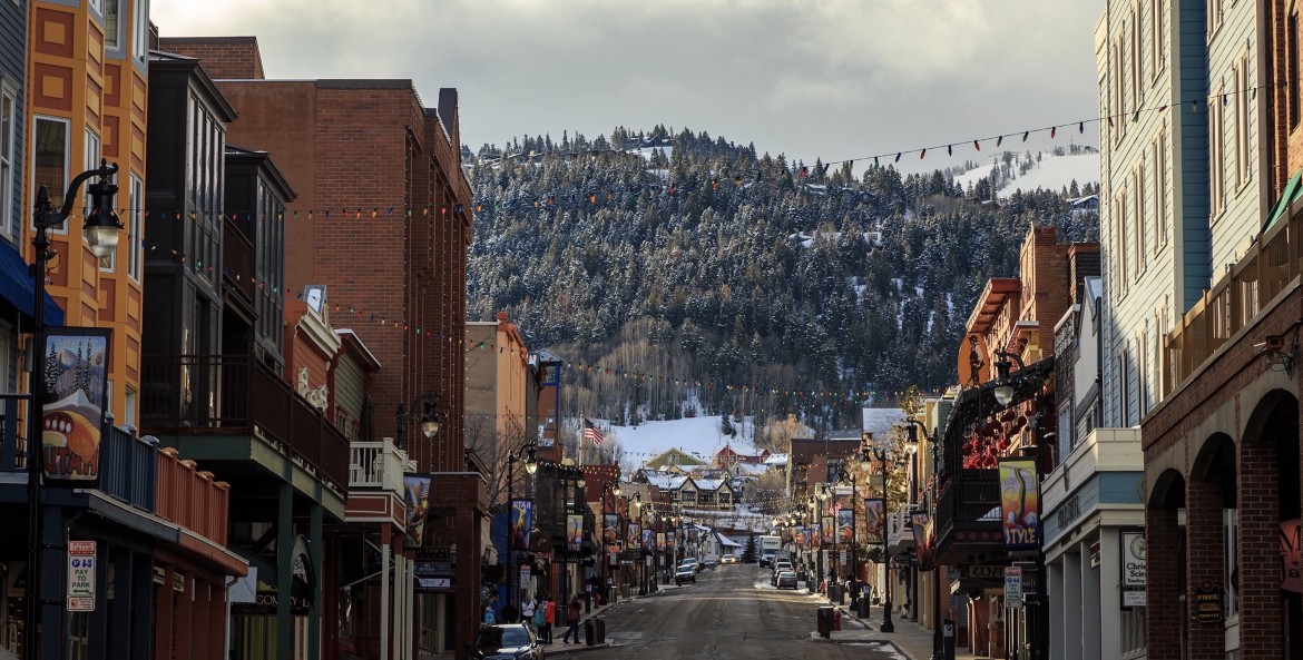 Main Street in Park City, Utah, looking towards the mountains with clouds in the sky