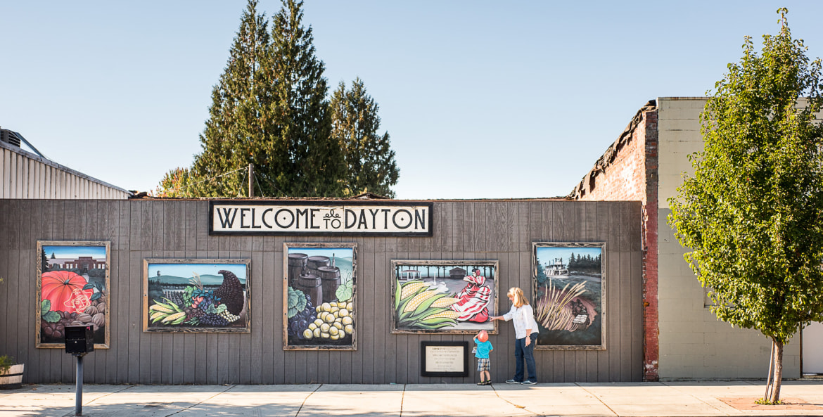 murals examined by woman and child along Ferry Street in Dayton, Oregon, picture