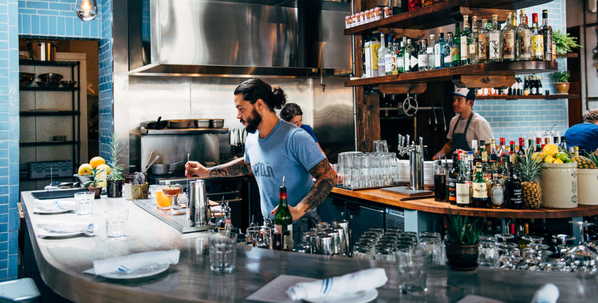 The bartender at Manolin in Seattle serves up Caribbean-inspired cocktails, image