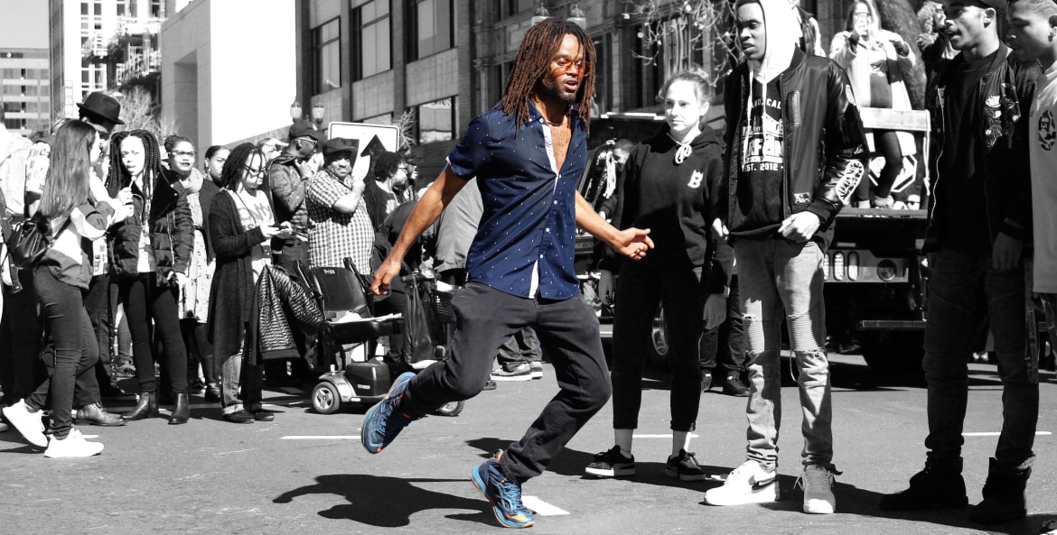 a picture of a man dancing for the crowd during the Black Joy Parade in Oakland, California.