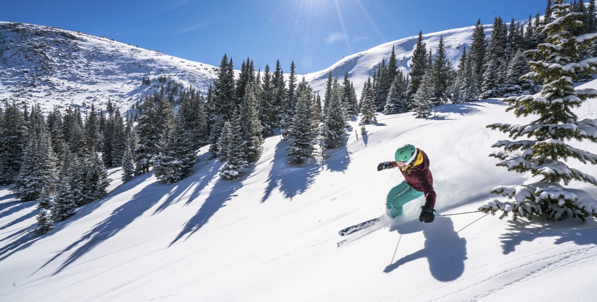 A woman skis down a run at Winter Park Resort in Colorado, photo
