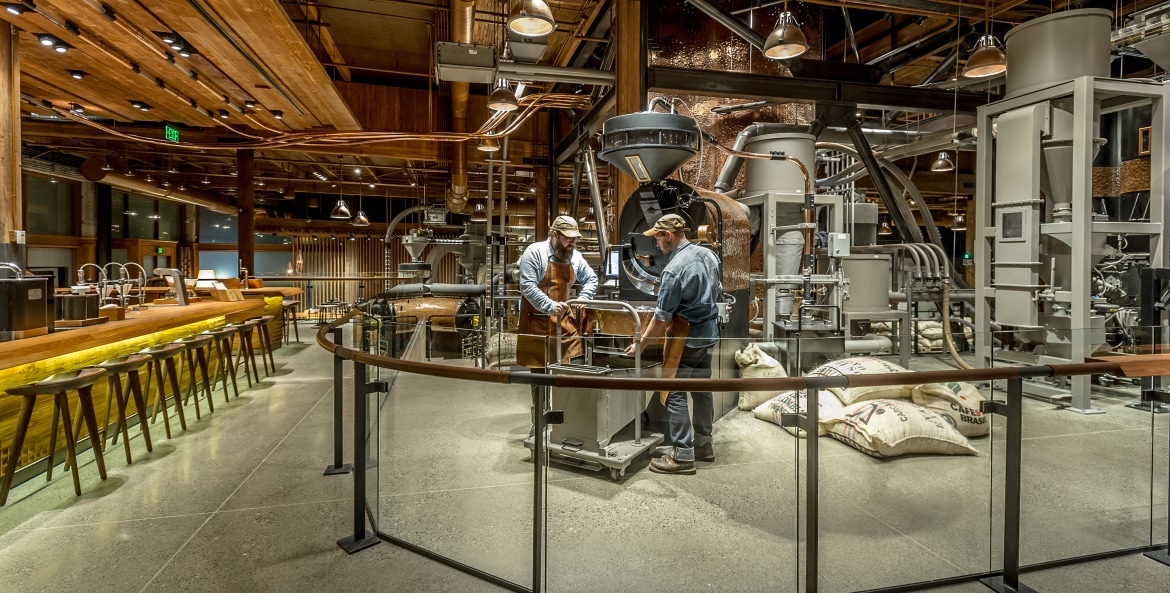 Two workers load coffee beans at the Starbucks coffee roasting factory in Seattle, Washington, image