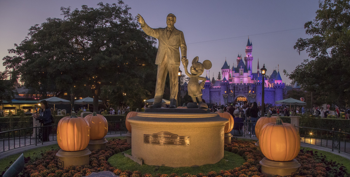 Walt Disney and Mickey statue at Disneyland during Halloween with pumpkins
