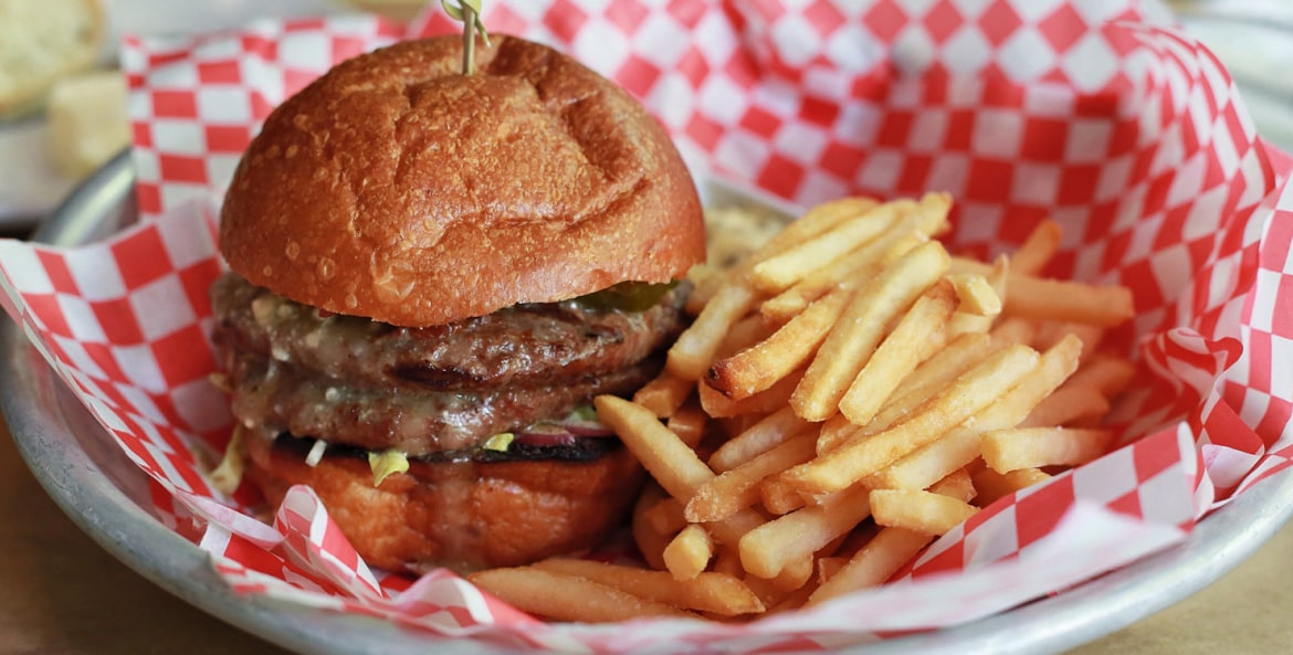 double brie burger with fries at Little Bird Bistro in Portland, Oregon.