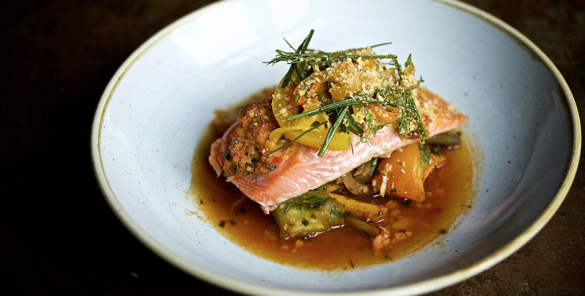 salmon, the fish of the day, with green tomato, rosemary and broth in shallow white bowl at Le Pigeon in Portland, Oregon, picture