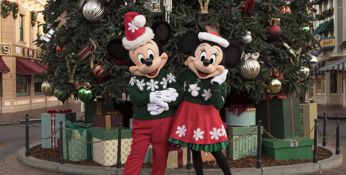 Minnie and Mickey in their holiday best in front of a Christmas tree at Disneyland, picture