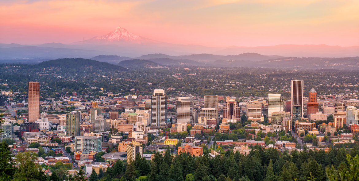 Portland, Oregon skyline stretches from downtown to Mount Hood in the distance at sunset, image