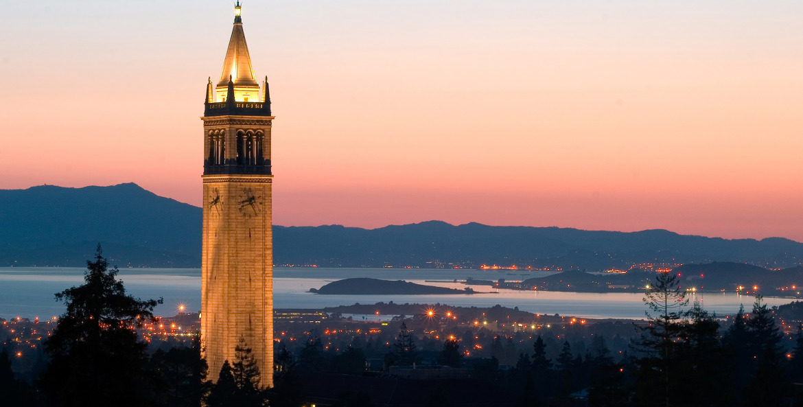 Sather Tower rises over the campus and city at sunset at University of California, Berkeley, photo