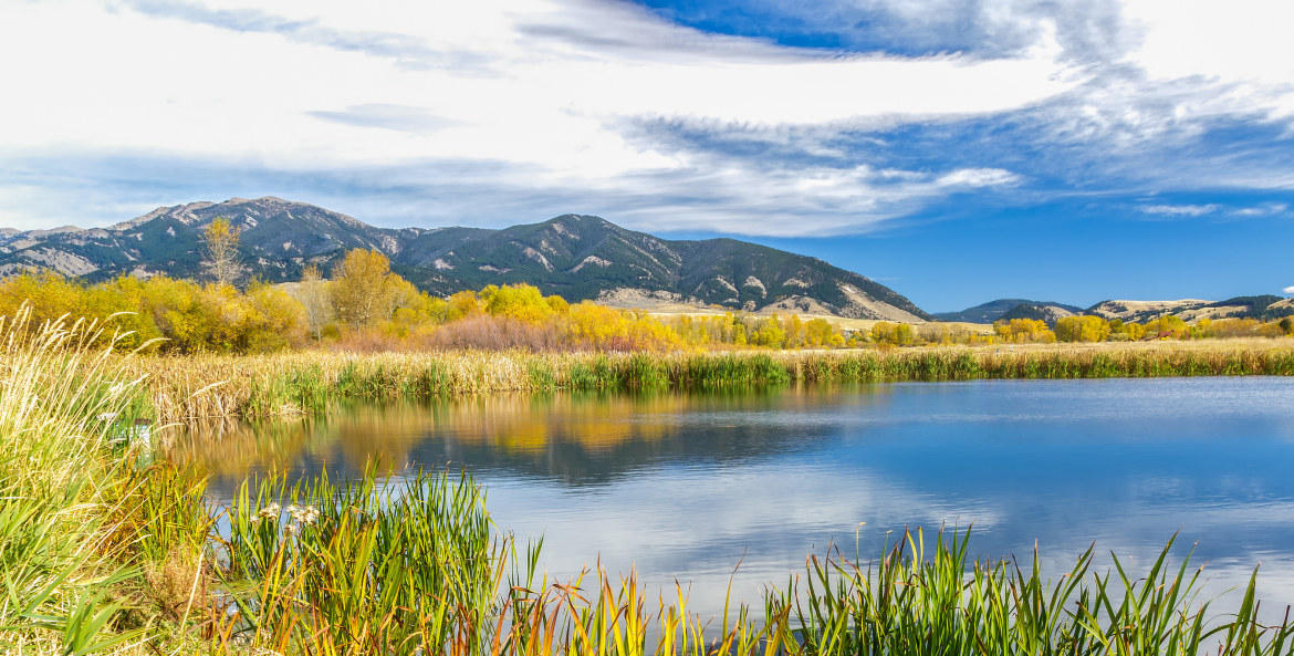 A beautiful reservoir in autumn fields at the foot of the Bridger mountain range in Cherry Creek Nature Preserve, picture