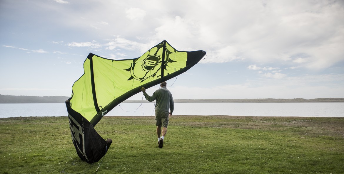 a kiteboarder on the edge of Floras Lake, Oregon