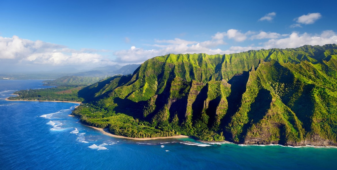 aerial view of surf breaking against rocky and lush Nā Pali Coast on Kauai, Hawaii, picture