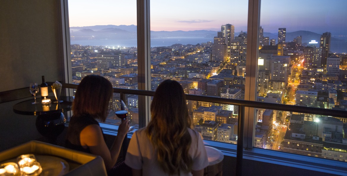 People look out at the San Francisco skyline at the Cityscape Lounge, picture