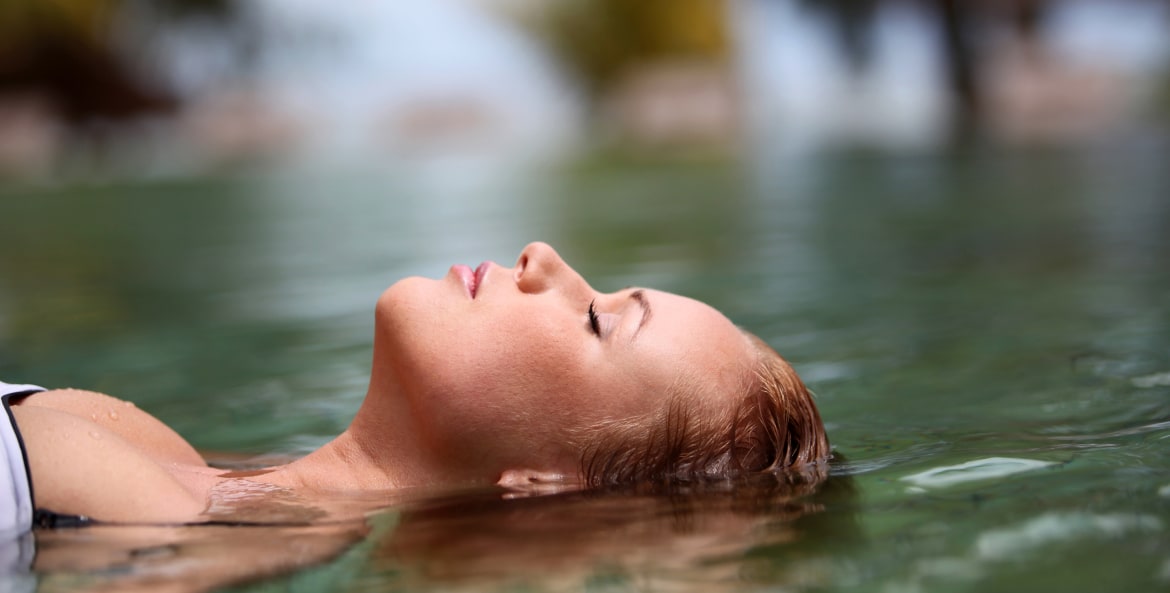 woman relaxing in a hot spring pool with eyes closed, picture