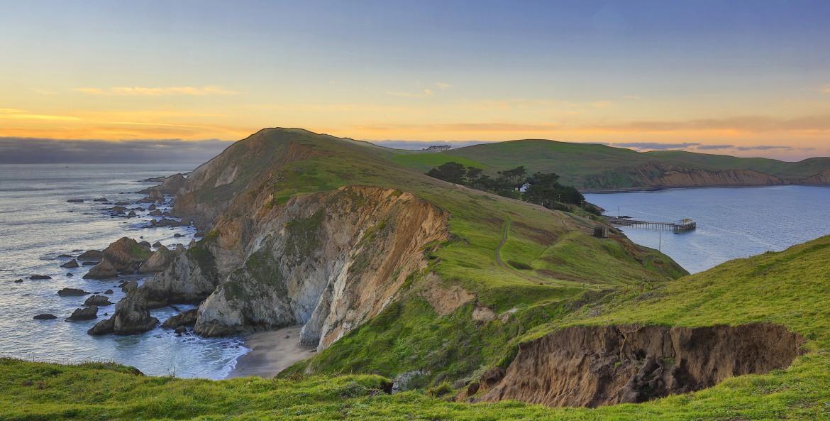Bright green bluffs bordered by the Pacific Ocean in Point Reyes National Seashore, California, picture