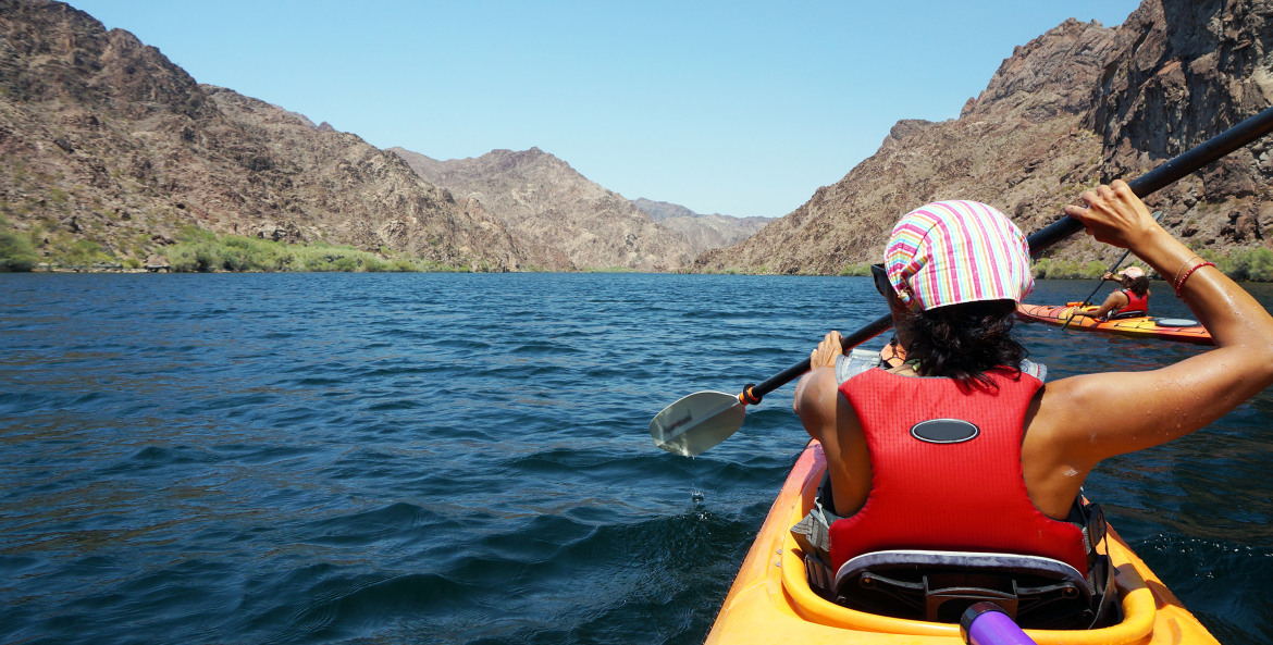 a woman kayaks in Black Canyon in Nevada on the Black Canyon National Water Trail near the Hoover Dam, image