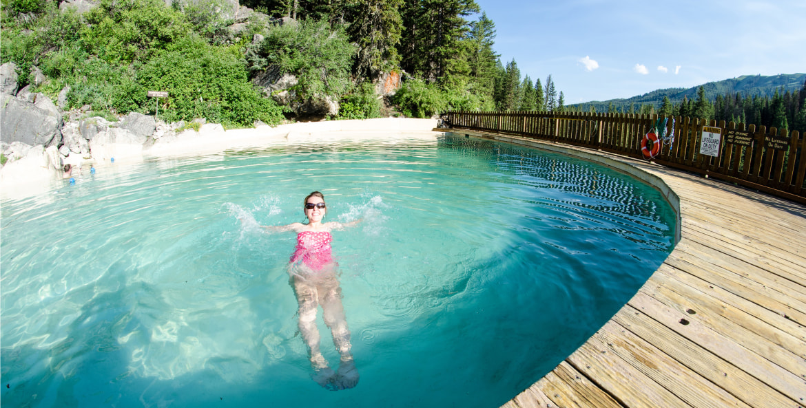 A woman with a pink bathing suit in the hot springs at Granite Hot Springs Pool in Wyomings Bridger-Teton National Forest, picture
