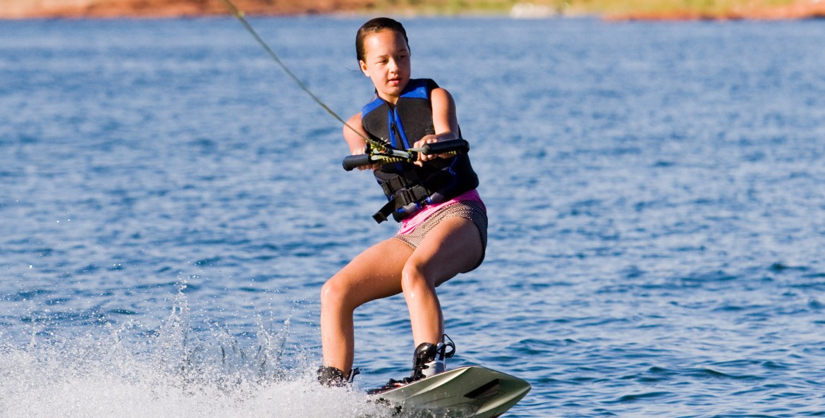 Girl wakeboarding on Lake Powell in Arizona, image