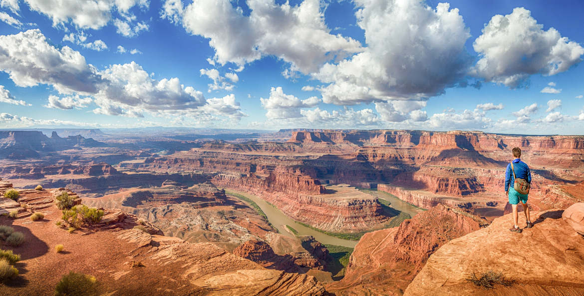 A hiker overlooks Dead Horse Point State Park in Moab, Utah, picture