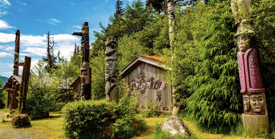picture of totem poles and clan houses in Alaska