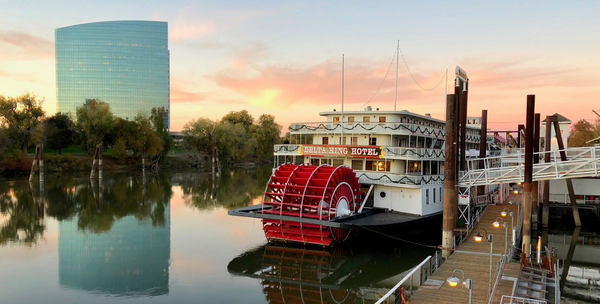 The Delta King riverboat cruises the Sacramento River at Sunset, photo