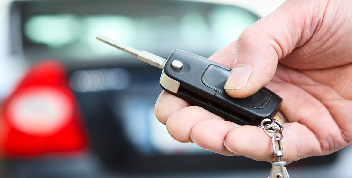 Holding a car key in hand, image