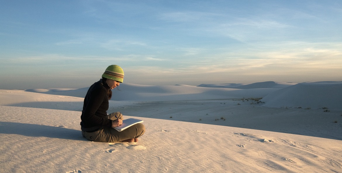 woman sitting on ground sketching at White Sand Dunes National  Monument, New Mexico, picture