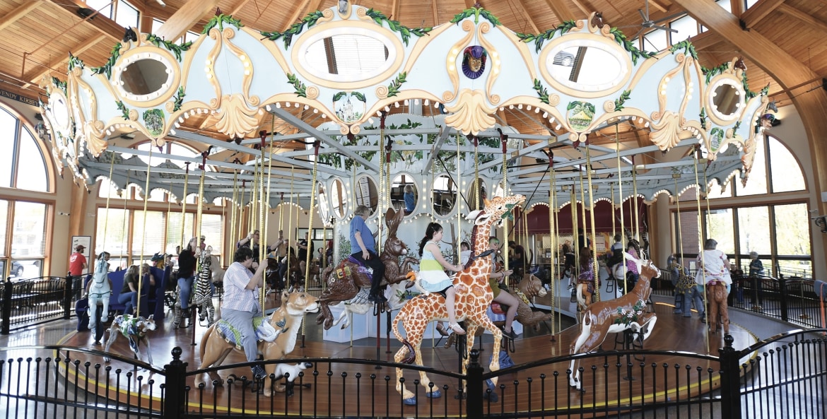 hand-carved wooden animals with riders, both young and old, at the Historic Carousel & Museum in Albany, Oregon, picture