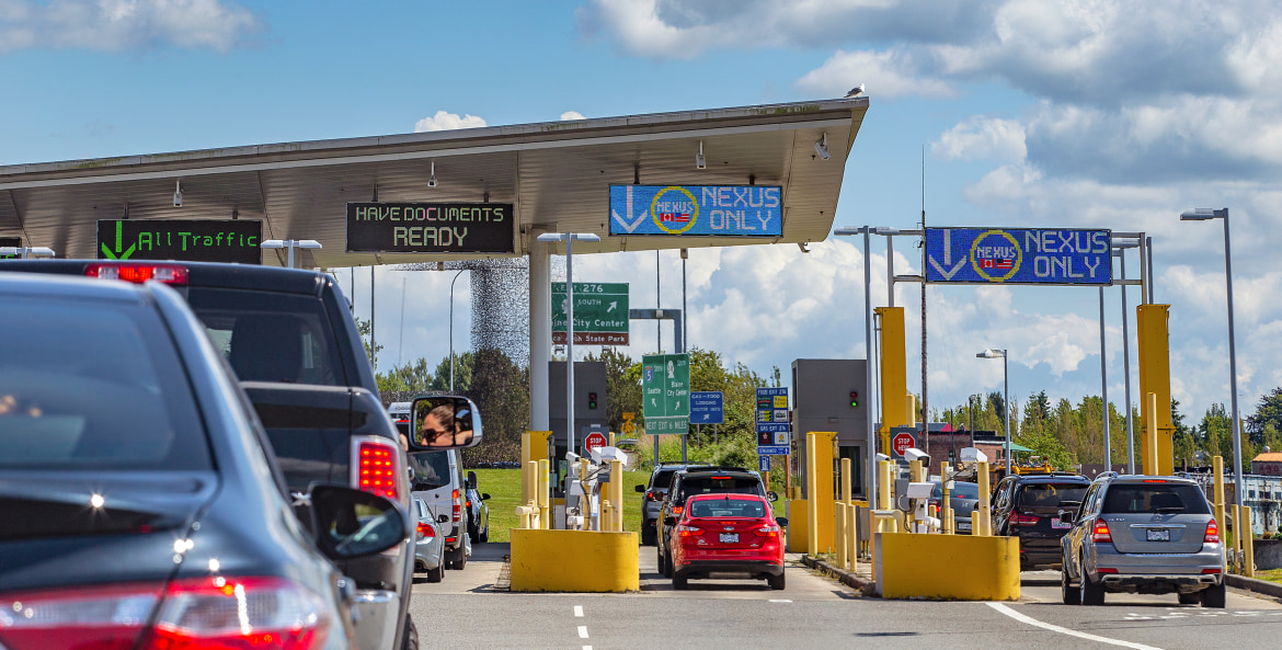 Cars wait in line at the U.S.-Canada border to drive into Canada