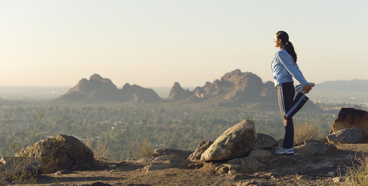 Woman stands atop Camelback Mountain in Paradise Valley, Arizona, image