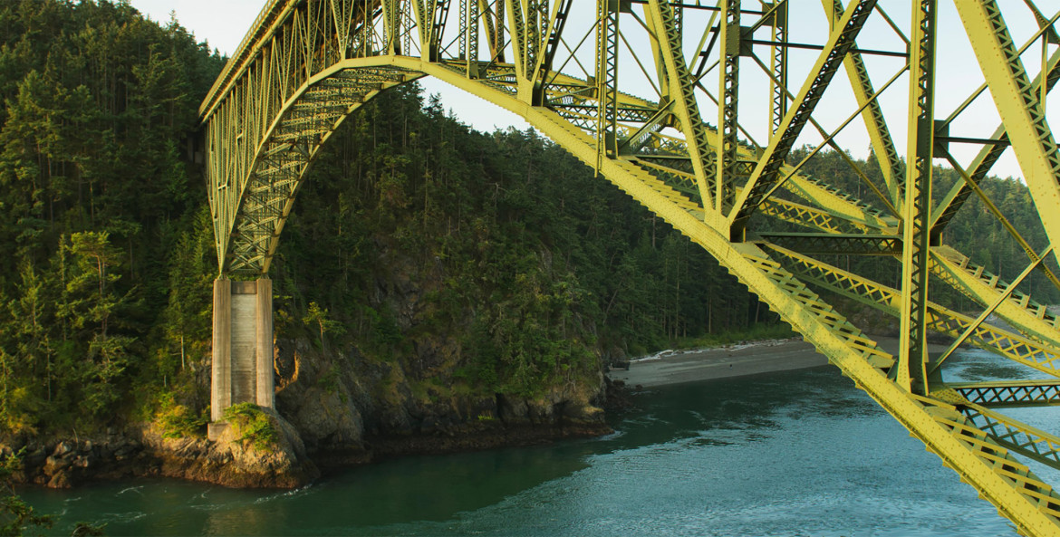 fishing boat passes under Deception Pass Bridge between Whidbey and Fidalgo Islands in Washington, picture