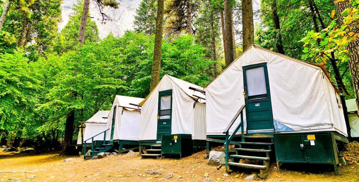 Metal bear-proof food lockers outside canvas tent cabins in Yosemite National Park's Half Dome Village, image