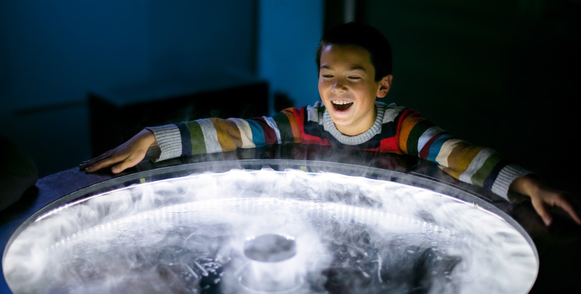 A boy plays with an exhibit at the Exploratorium in San Francisco.