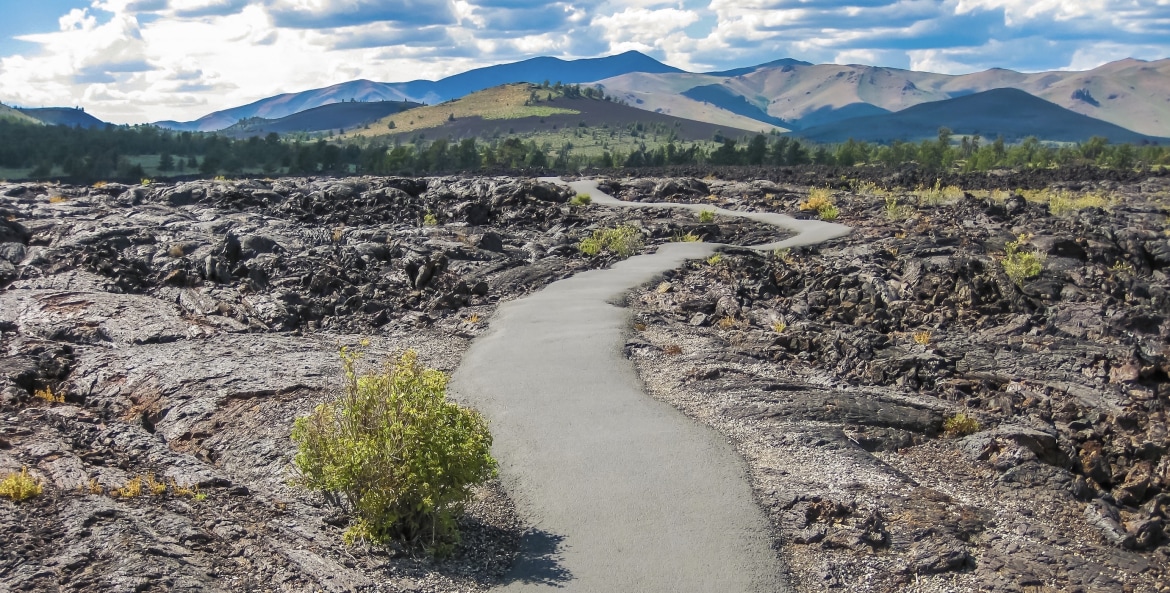 a path winds through desolate Craters of the Moon National Monument and Preserve in Idaho