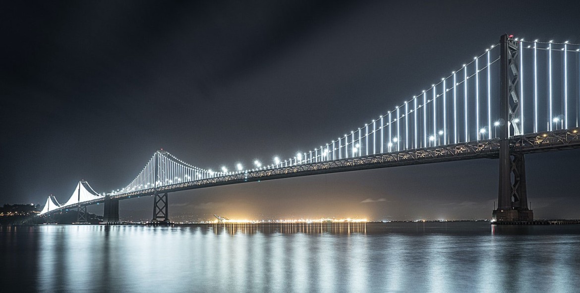 San Francisco Oakland Bay Bridge lit up at night.
