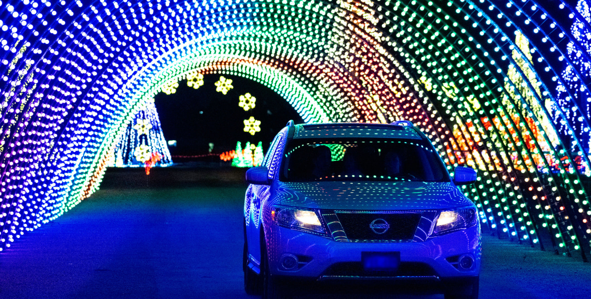 A car drives through a light tunnel at Christmas in Color in Salt Lake City.