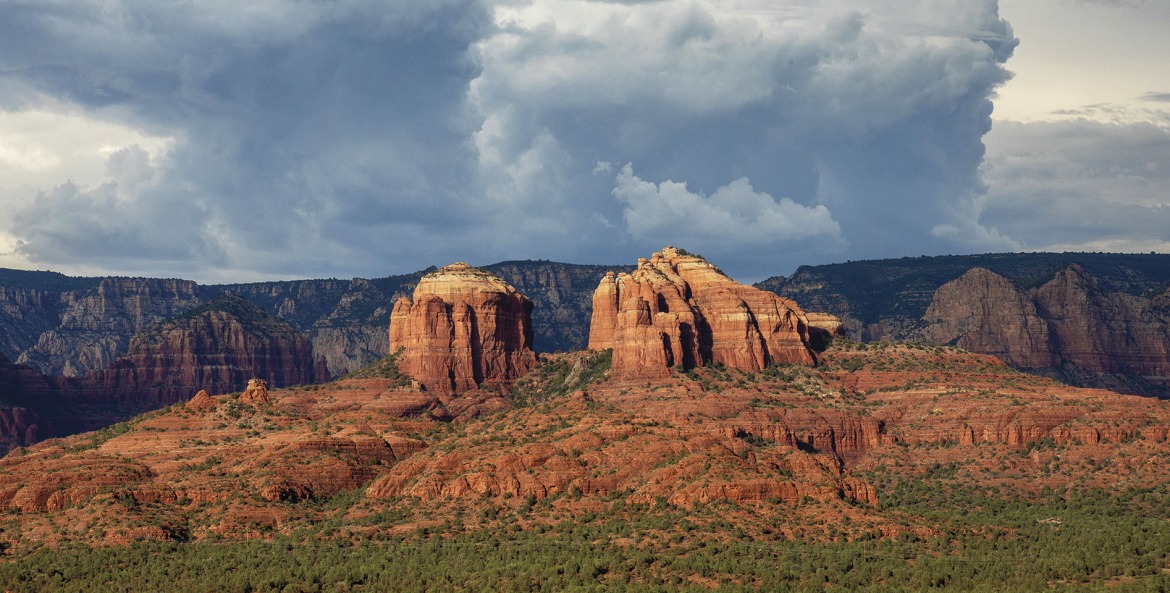 dramatic panorama with rock formations backed by storm clouds at Red Rock State Park in Sadona, Arizona