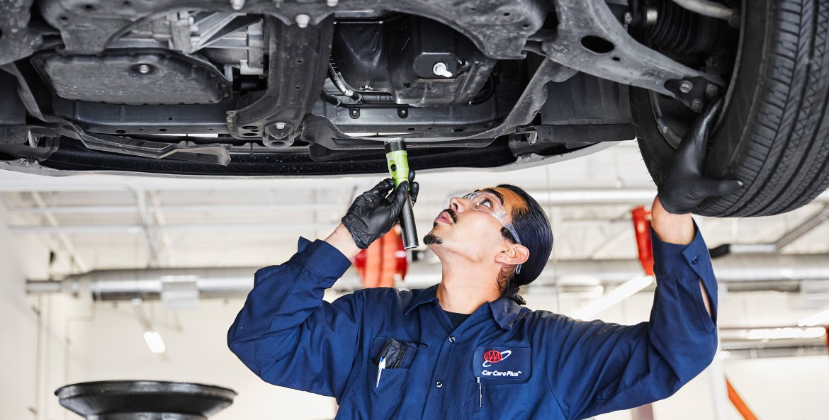 AAA Auto Repair mechanic inspects catalytic converter.