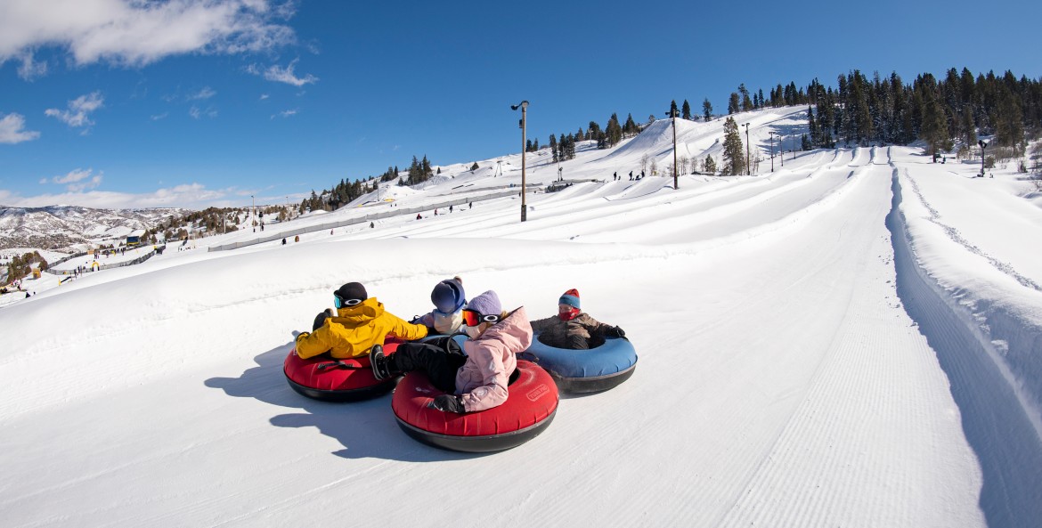 Riders slide down the large tubing hill at Woodward Park City in Utah.