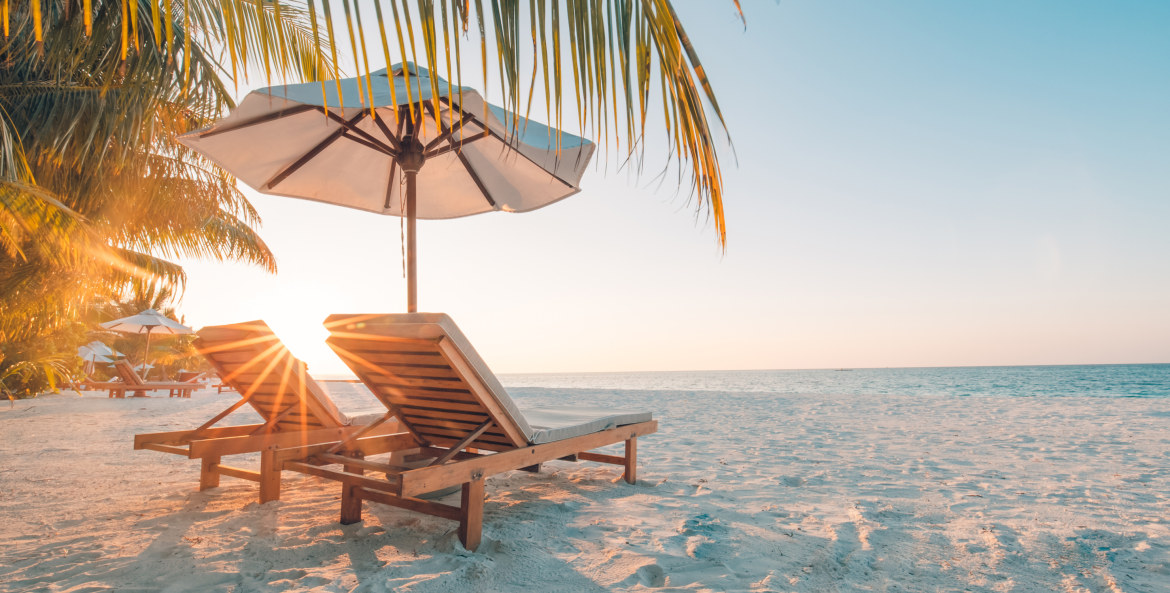 Lounge chairs on a tropical beach.