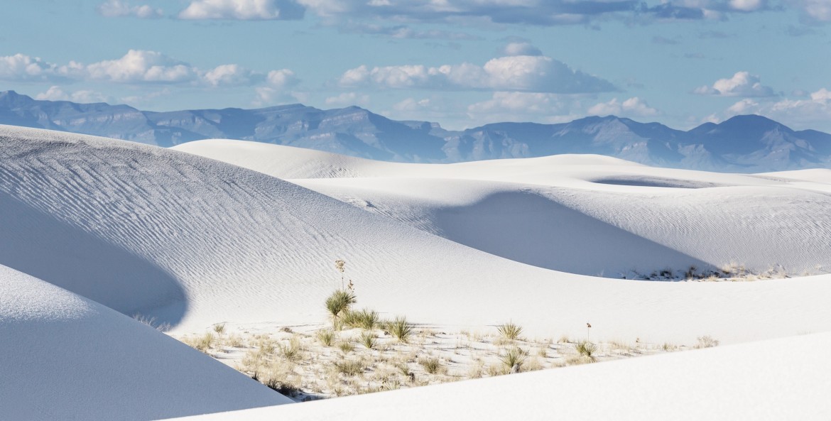 White sand dunes set against blue skies at White Sands National Monument, picture