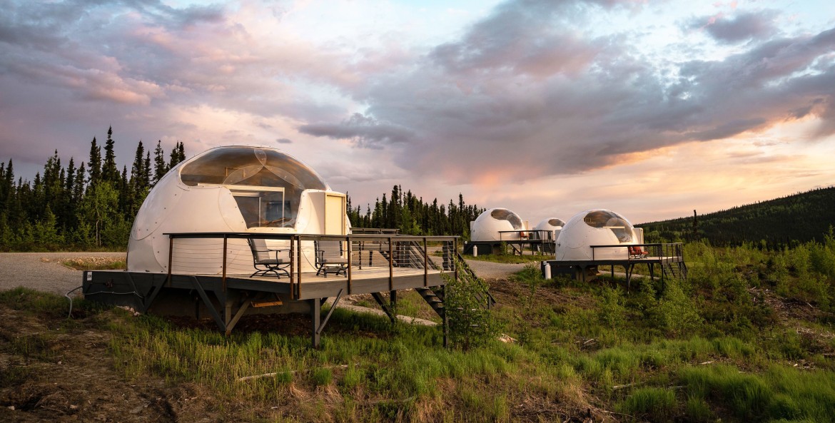 Plastic igloos in a field at Borealis Basecamp in Fairbanks, Alaska.