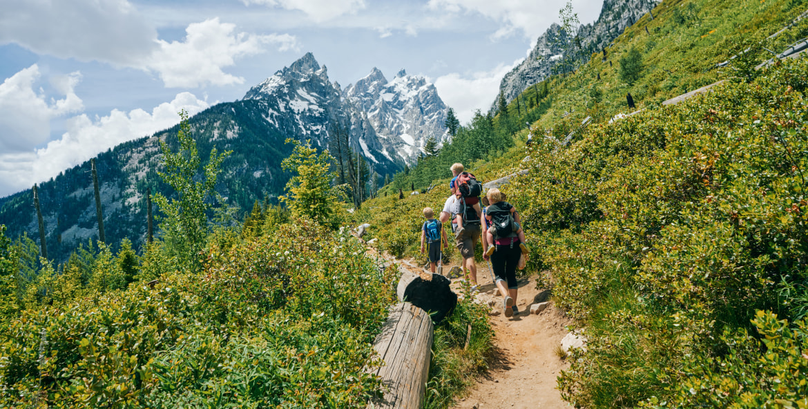 A family hike on a trail in Grand Teton National Park.