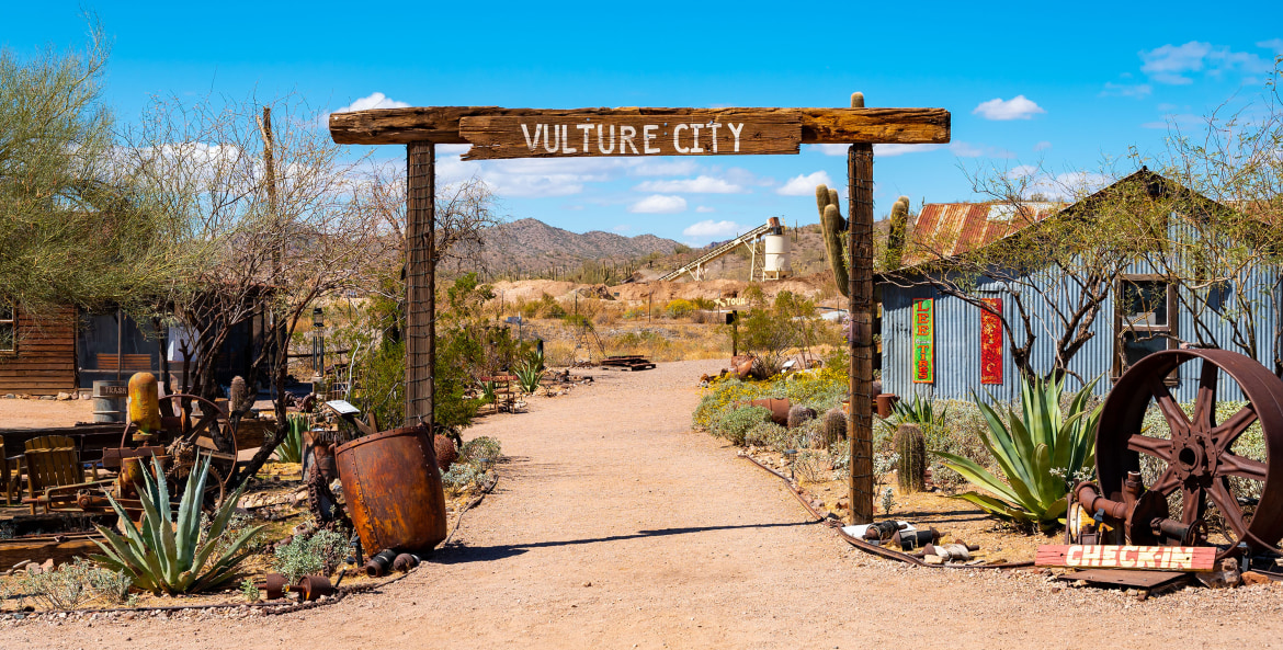 A wooden sign over the road in Vulture City ghost town in Maricopa County, Arizona.