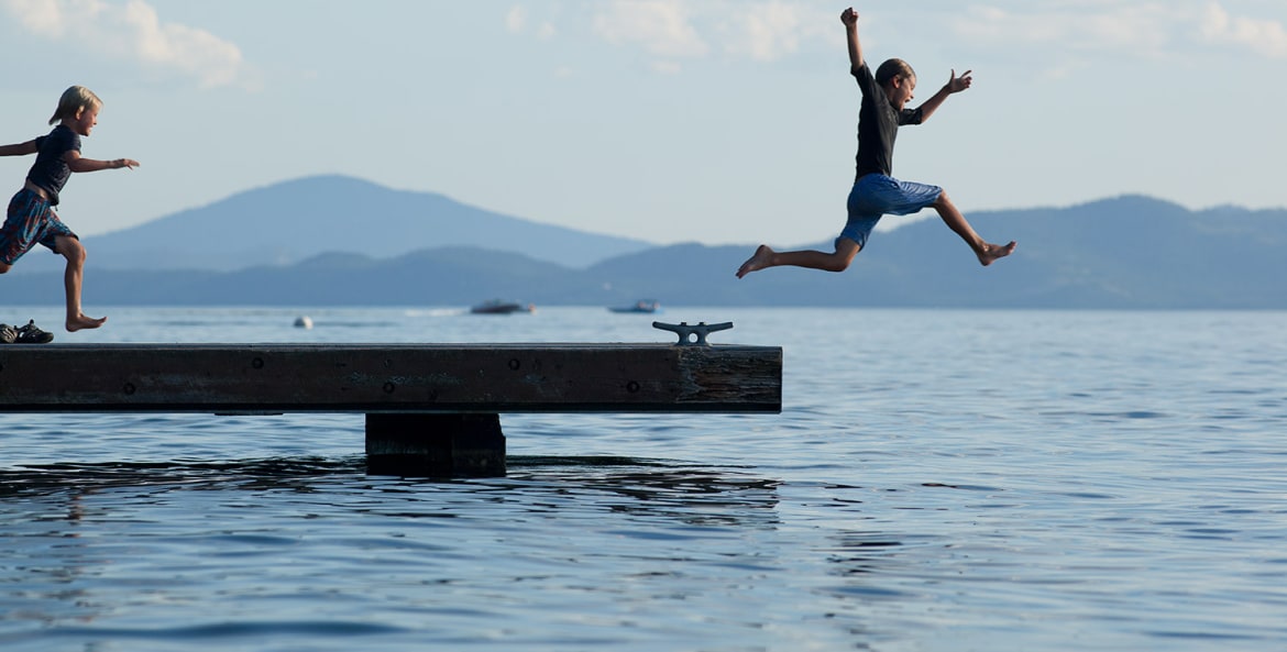 Kids jump off the dock at Flathead Lake Lodge.