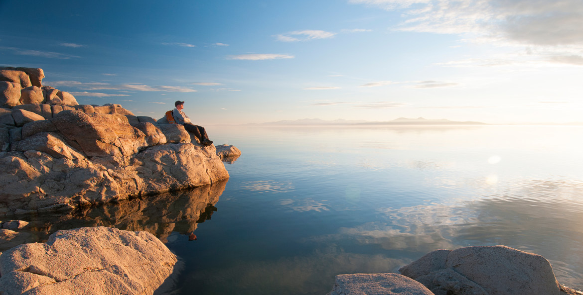 A hiker rests along the shore of the Great Salt Lake from Antelope Island State Park in Utah.