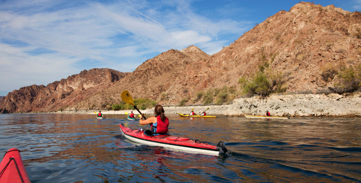a woman kayaks in Black Canyon in Nevada on the Black Canyon National Water Trail near the Hoover Dam